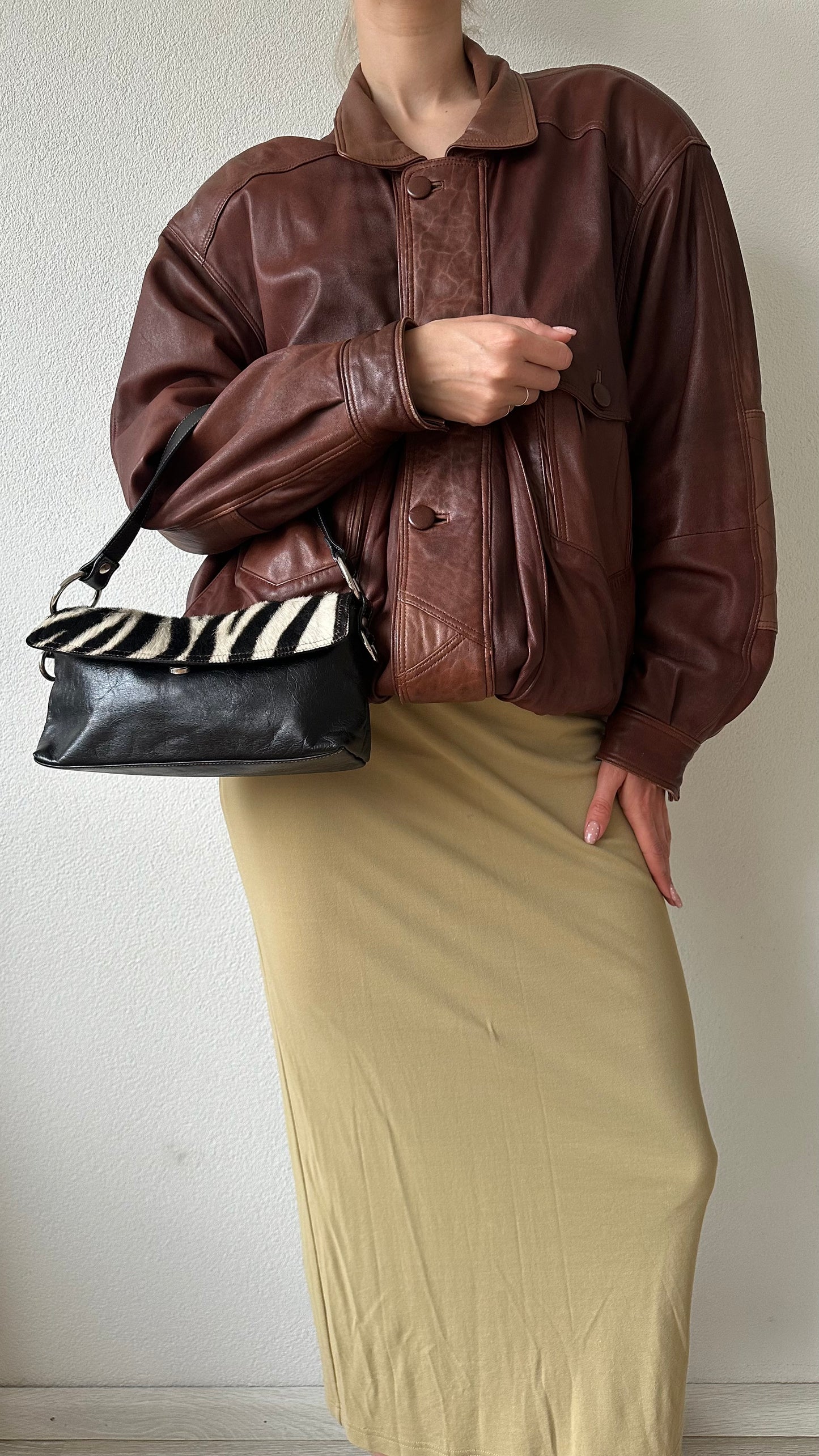 black leather handbag with zebra flap