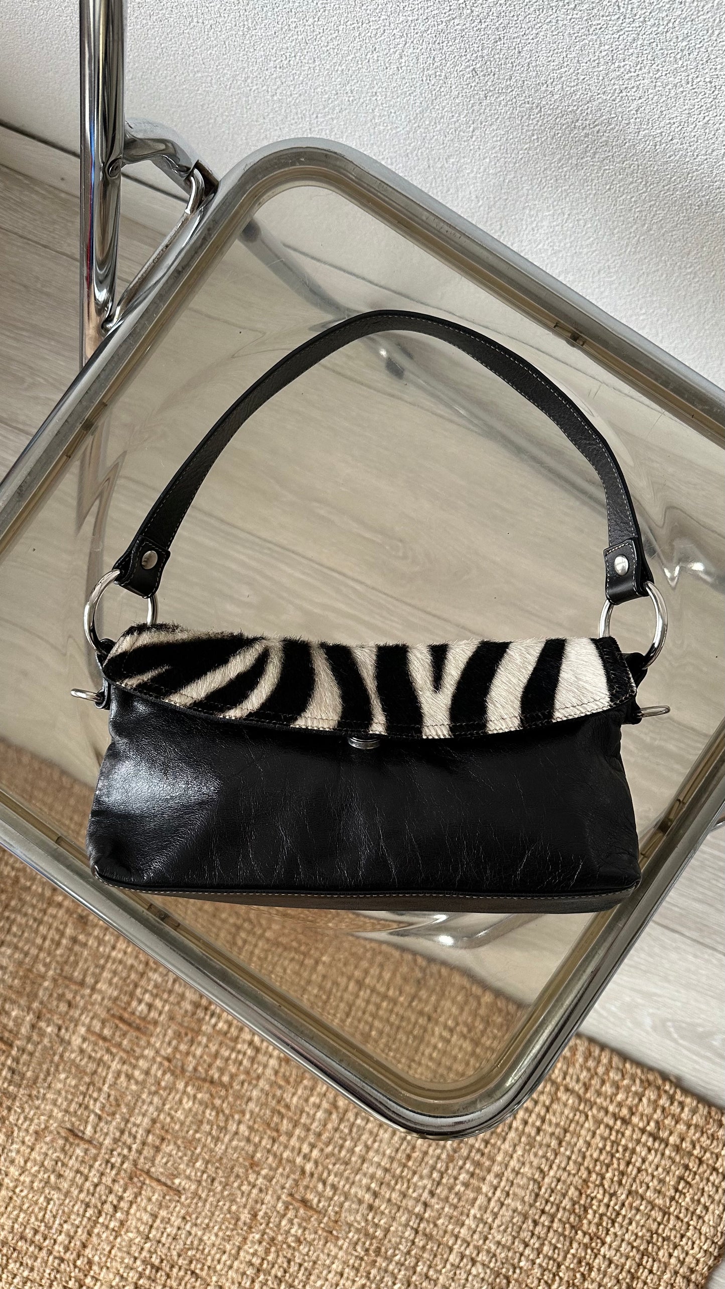 black leather handbag with zebra flap