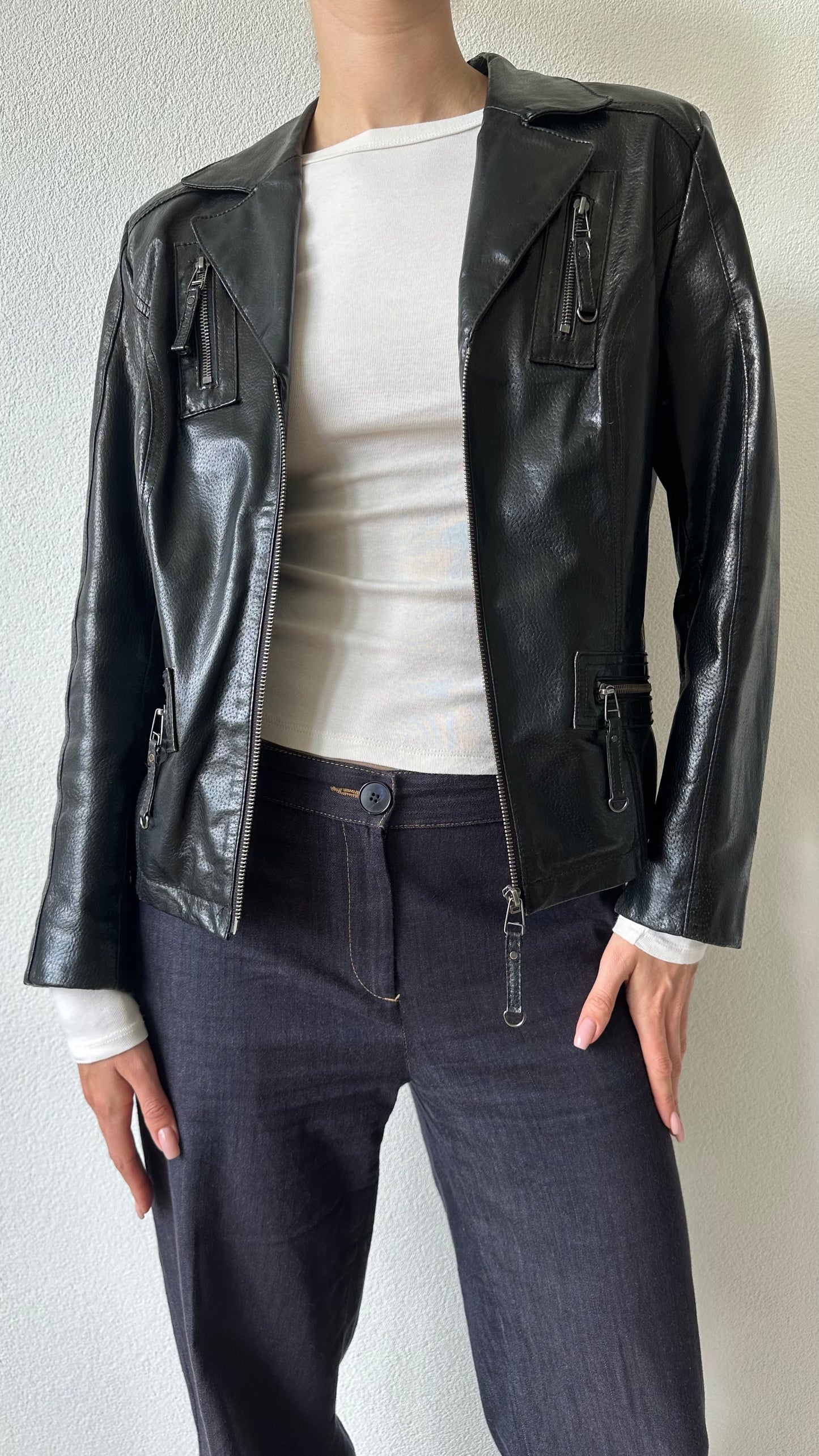 black shiny leather coat with zippered pockets