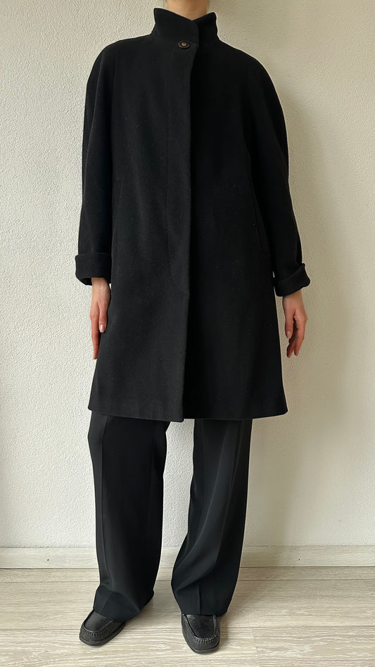 black wool coat with high collar and statement top button
