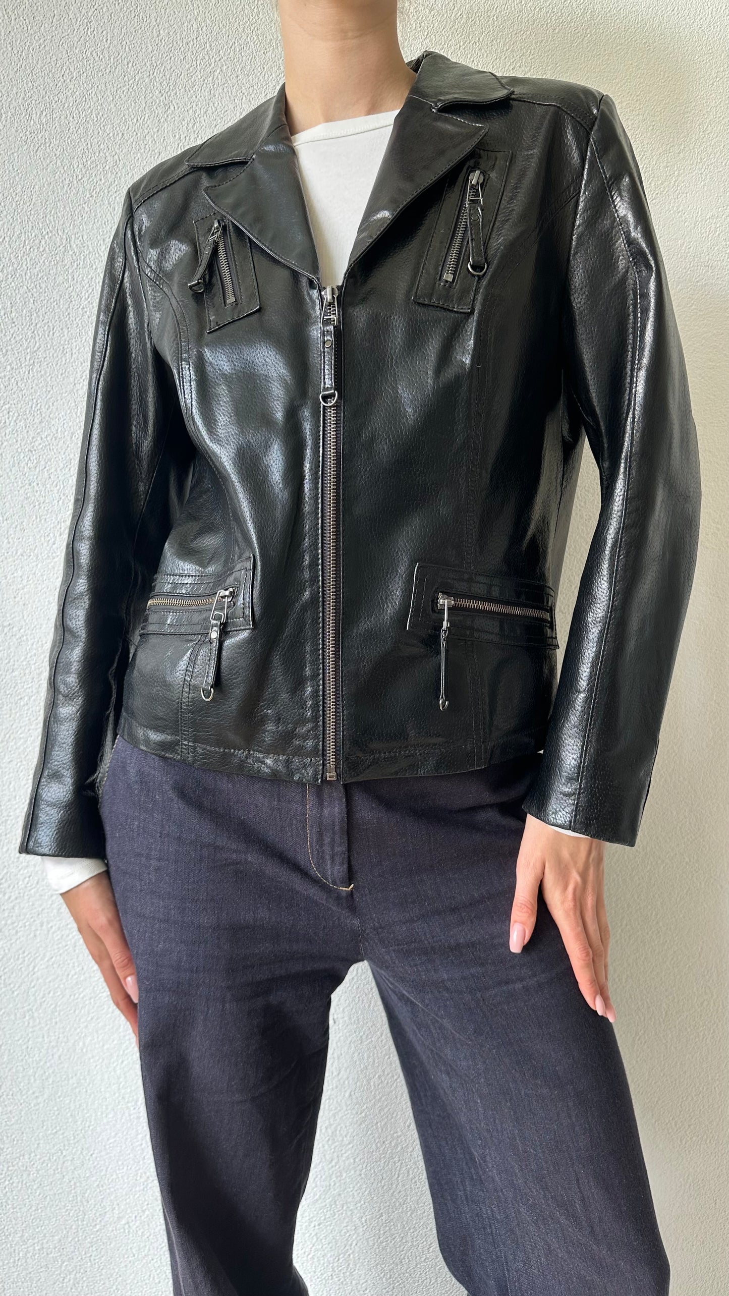 black shiny leather coat with zippered pockets