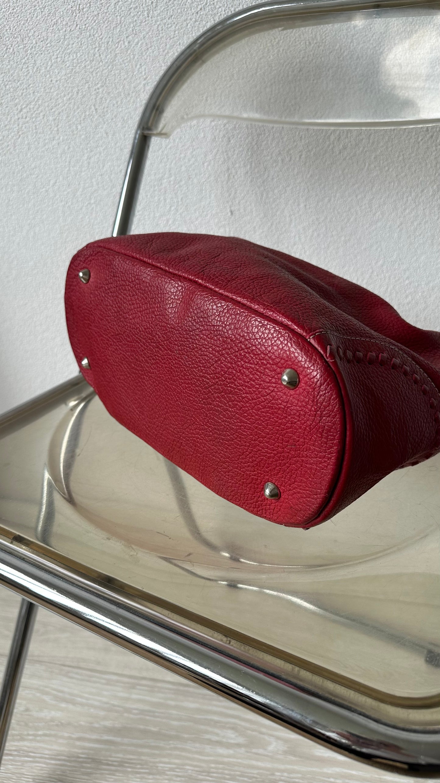 tods red leather bucket bag with silver hardware