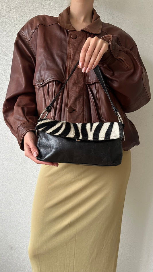 black leather handbag with zebra flap