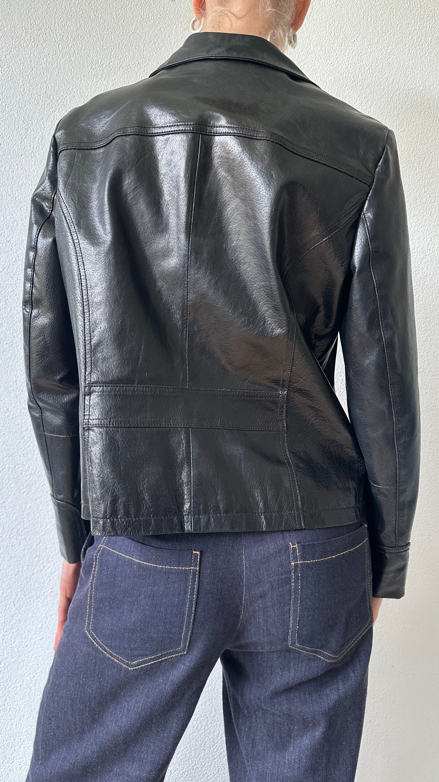 black shiny leather coat with zippered pockets