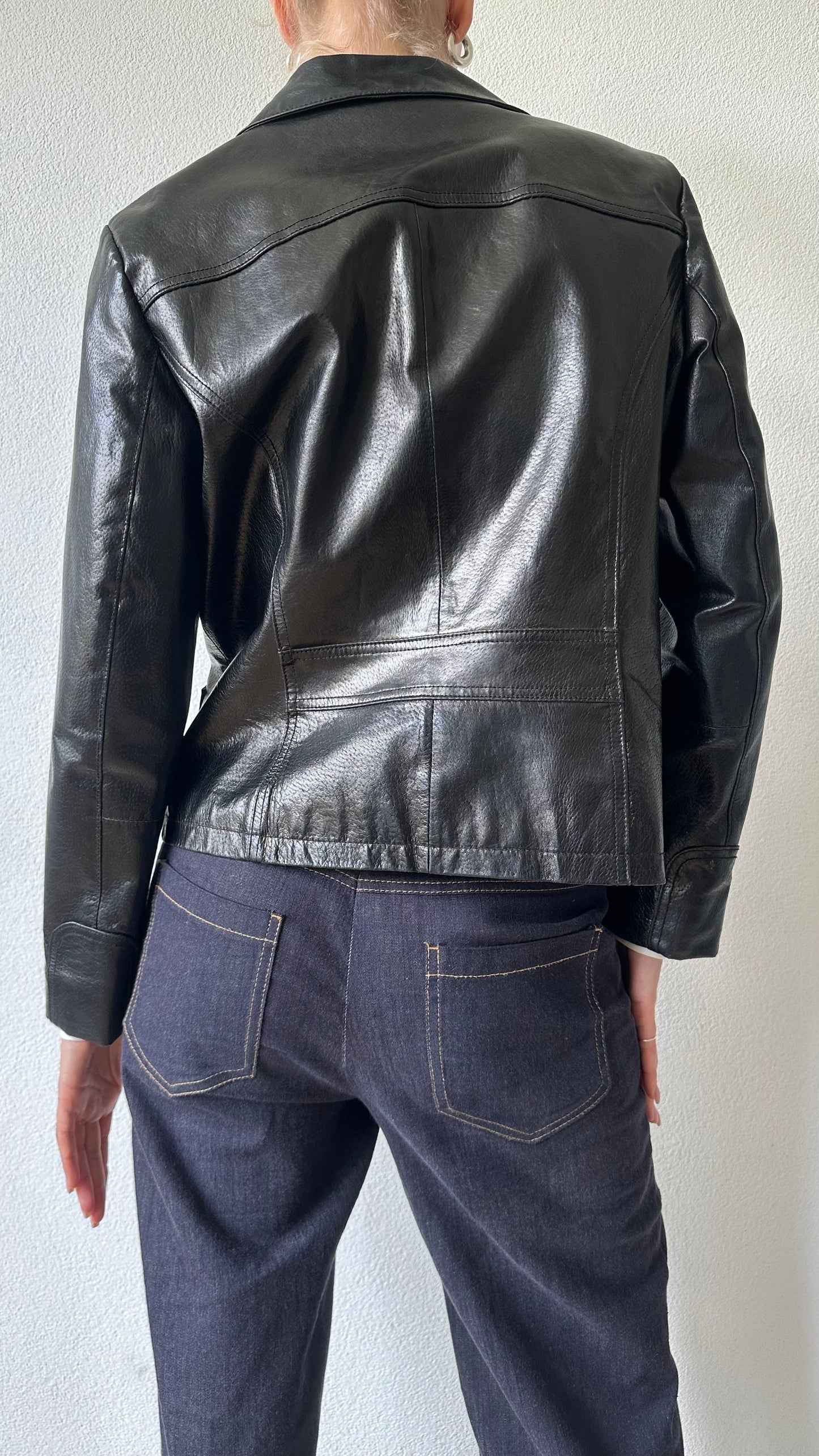 black shiny leather coat with zippered pockets