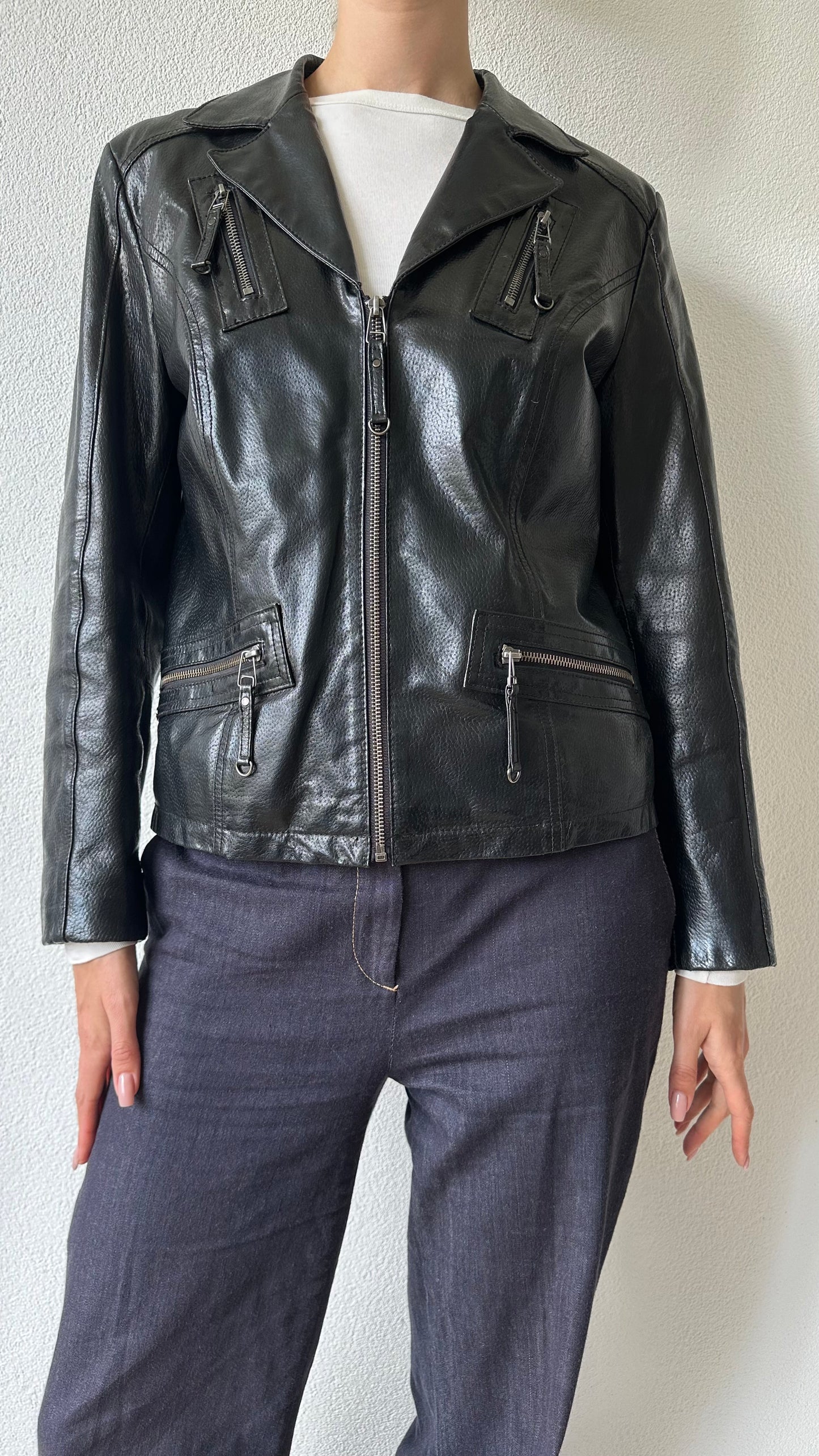 black shiny leather coat with zippered pockets