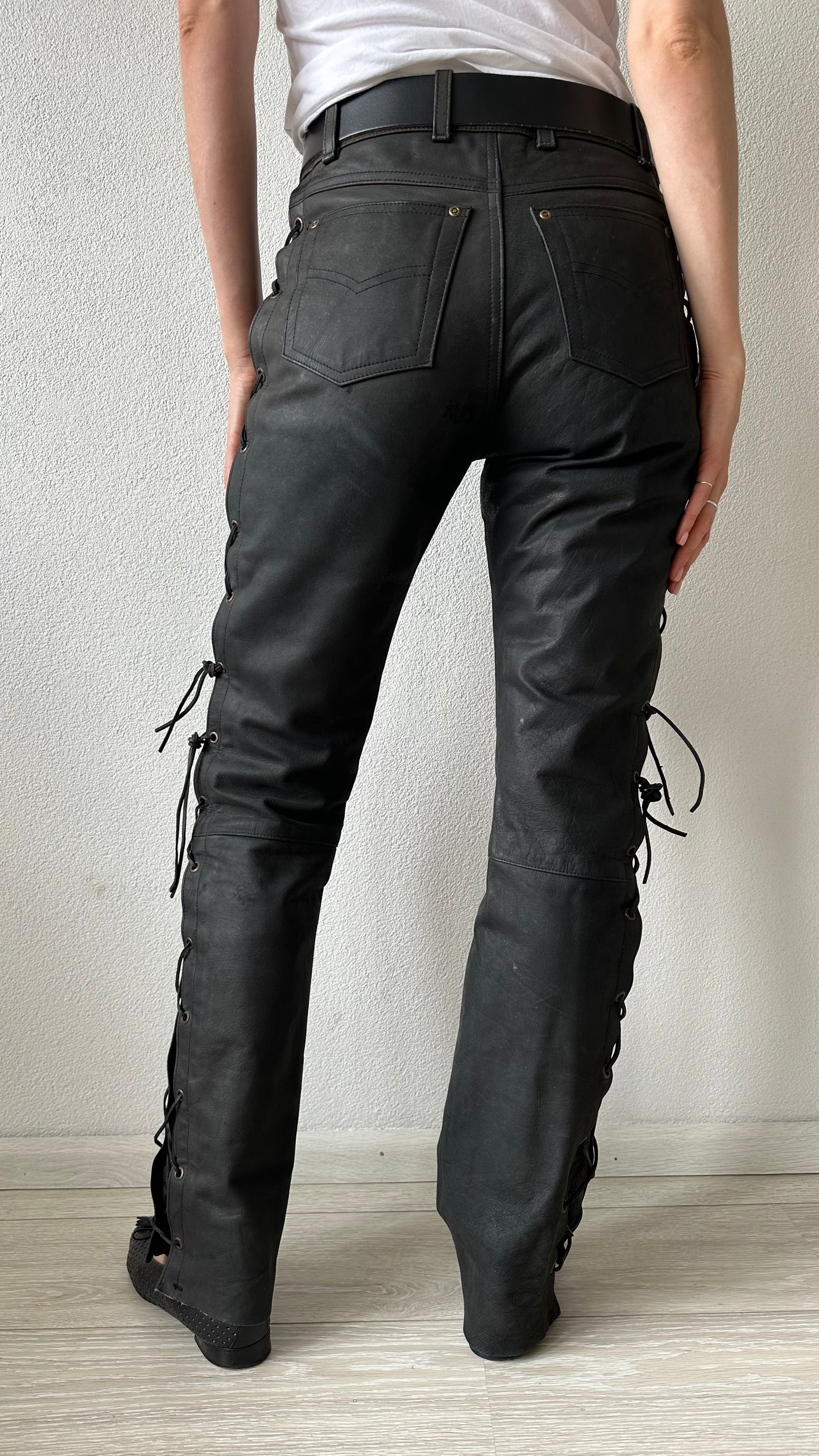 black leather trousers with braided sides and belt
